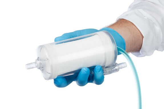 TandemLung Oxygenator with Gas Line in blue gloved hand, white sleeve