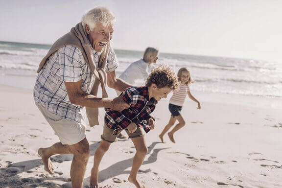 Grandparents and grandchildren enjoying life on the beach after VNS Therapy