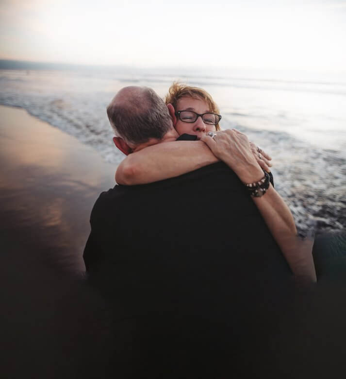 Couple at beach embracing in a hug