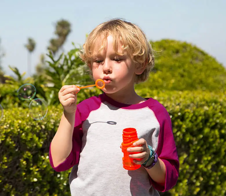 Child with VNS Therapy blowing bubbles