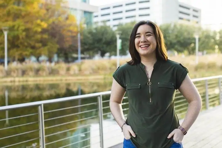 A woman with VNS Therapy™ standing on a bridge