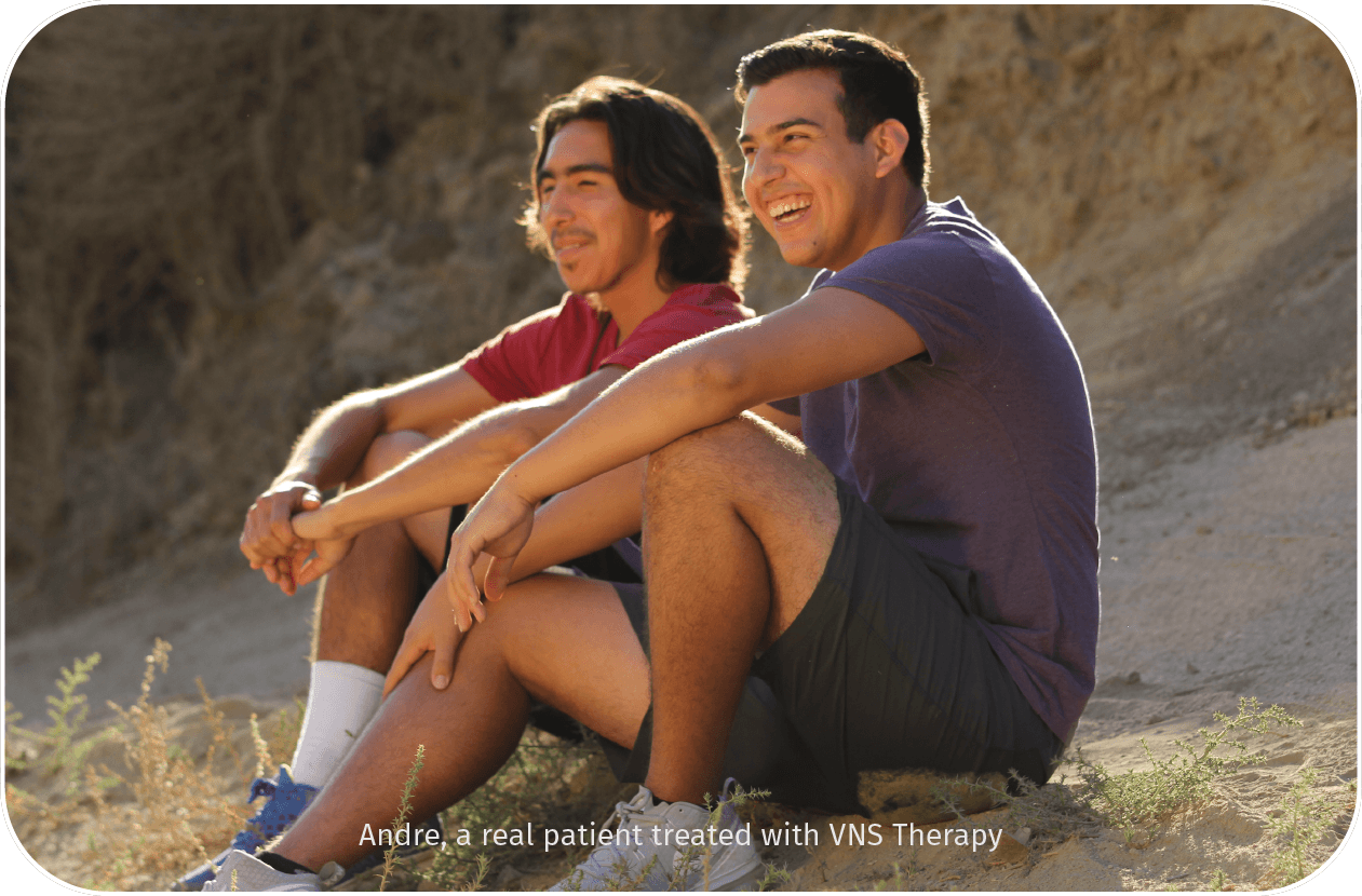 Two men sitting together outside
