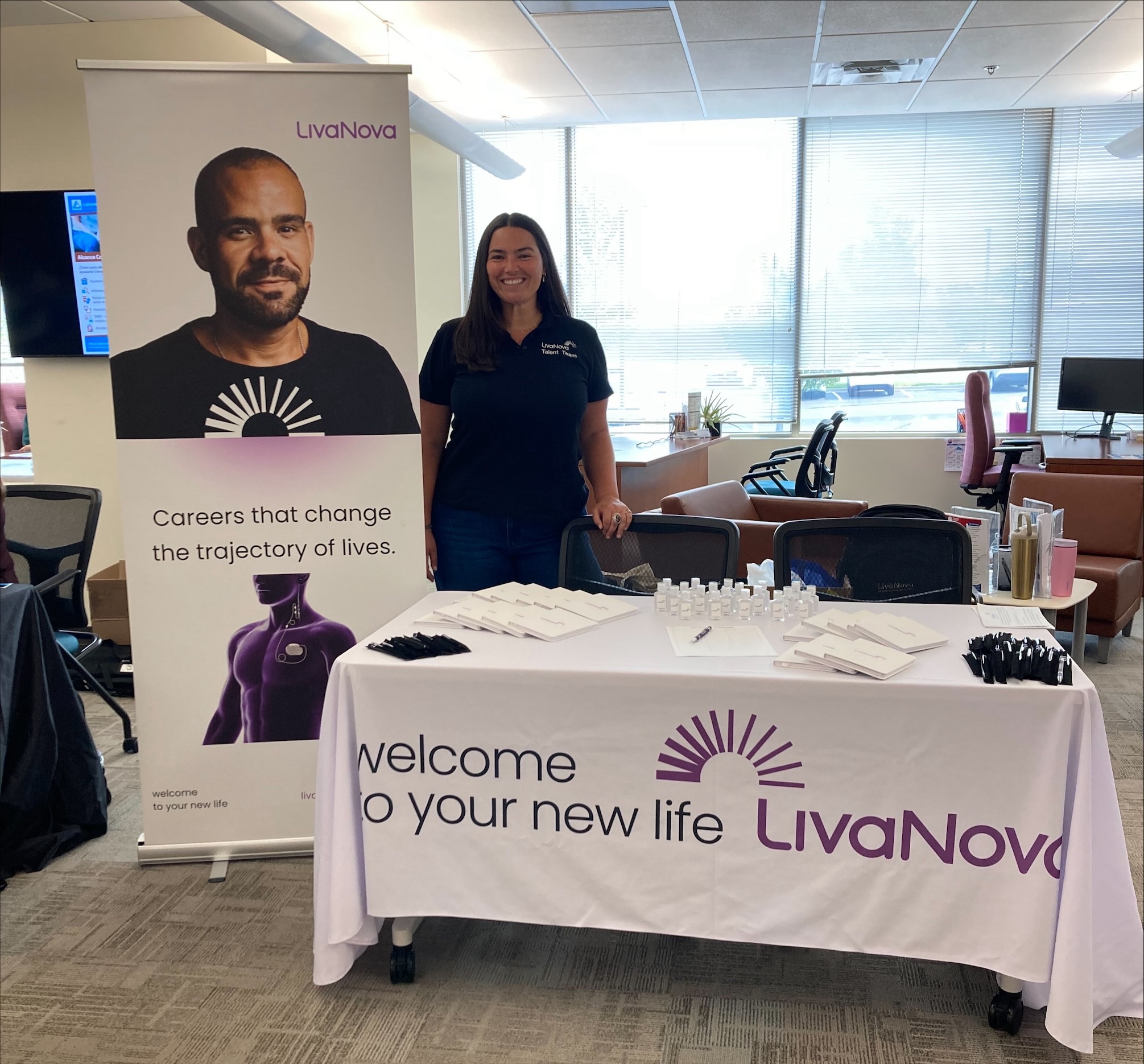 An employee at an information table while working 