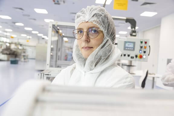 A woman working in a clean room lab room