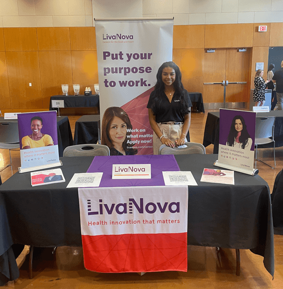 An employee at an information table while working 