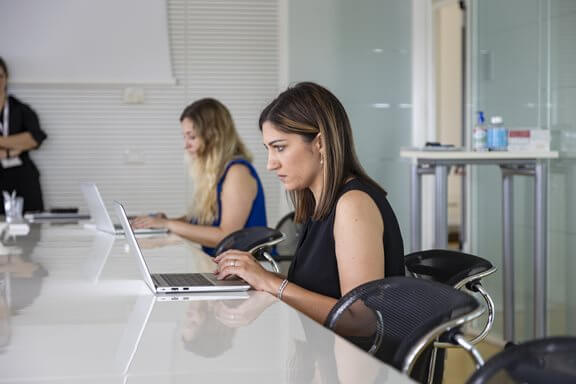 Employees working at computers next to each other