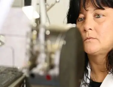 woman looking through a microscope