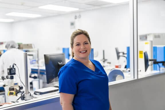 Employee in front of a lab