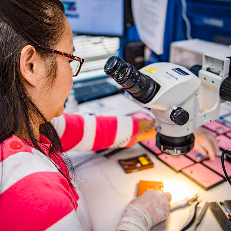 Employee working at a microscope