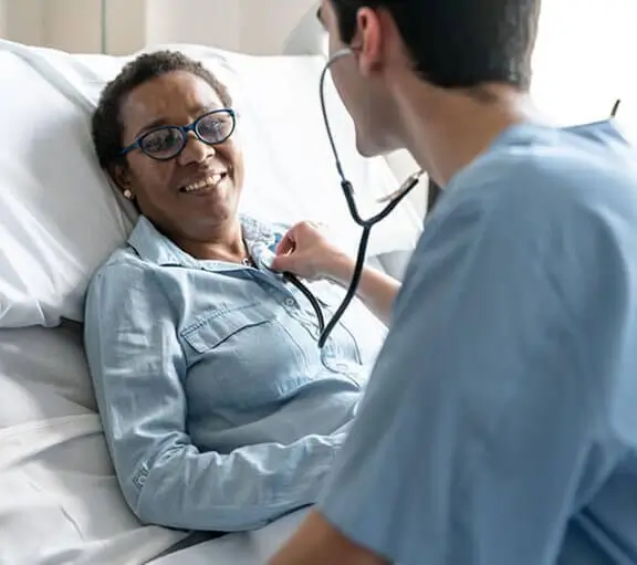 Doctor checking the heart rate of his patient
