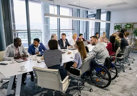 Diverse group of business people that are all sitting around a table in a conference room